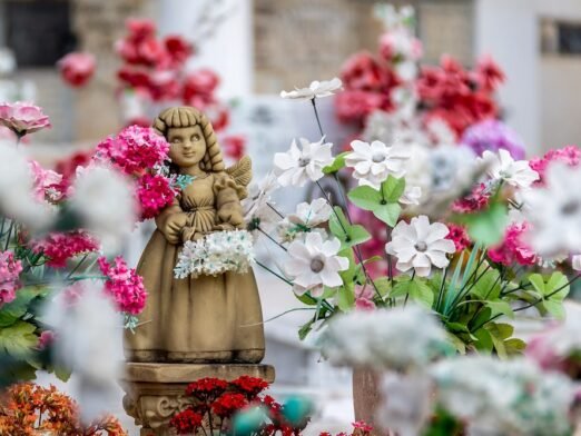 Cute angel girl statue and flowers